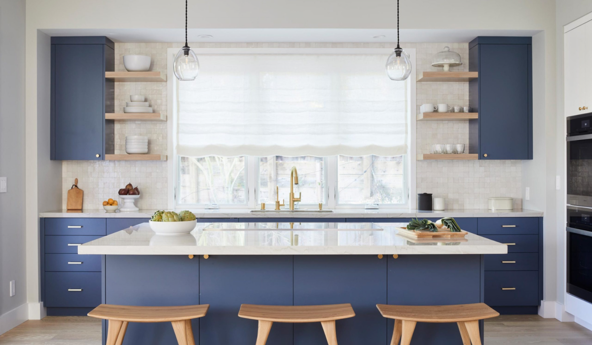 Coddington_design_Woodside_navy-kitchen-cabinets-white-oak-backsplash-bright-island-pendants