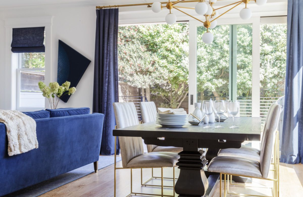 Coddington-bay-area-fresh-transitional-heirloom-table-area rug-dining-chairs-blue-opaque-glass-chandelier