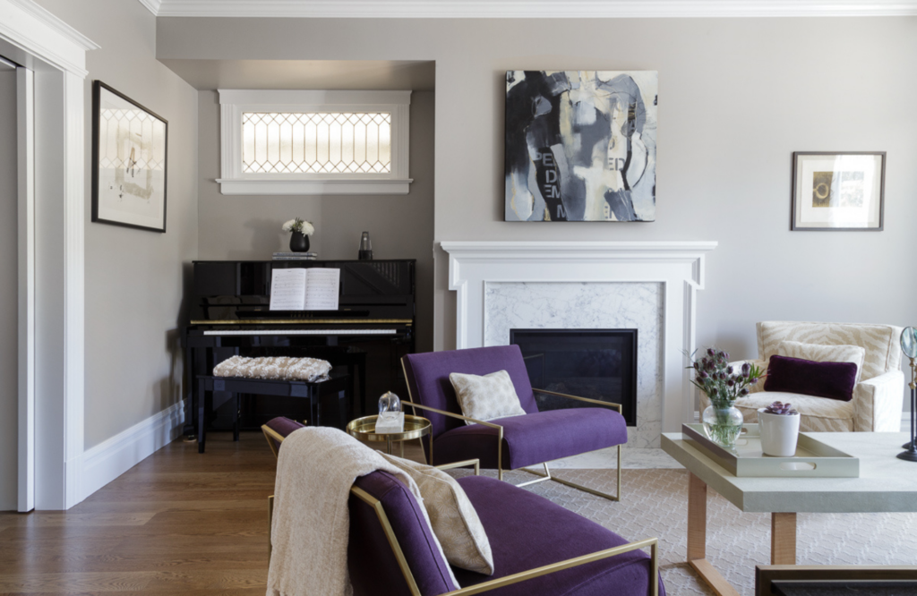 coddington-design-living-room-black-piano-fireplace-purple-accent-chairs-black-and-white-art-timeless